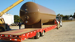 Painted ASME Code horizontal hydropneumatic drinking water tank on a truck